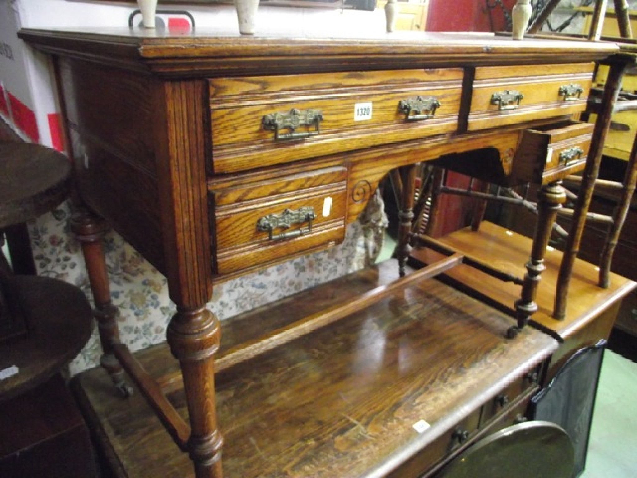 Appraisal: A late Victorian oak kneehole side dressing table fitted with