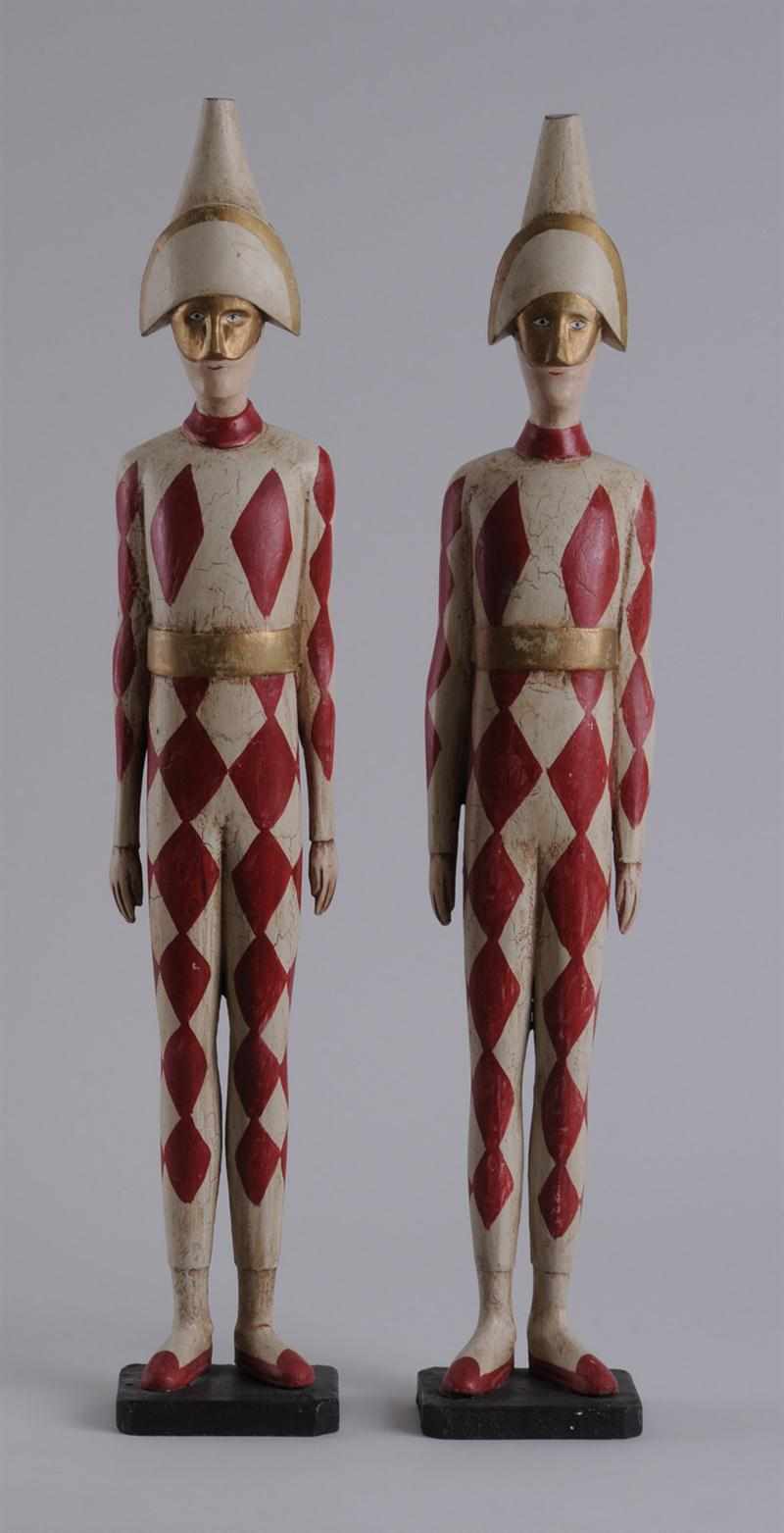 Appraisal: PAIR OF CARVED PAINTED AND PARCEL-GILT FIGURES OF ARLECHINNO Each