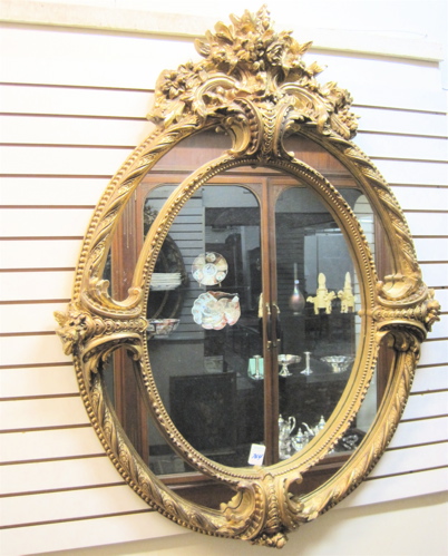 Appraisal: LOUIS XV STYLE OVAL WALL MIRROR with oval mirror-panel frame