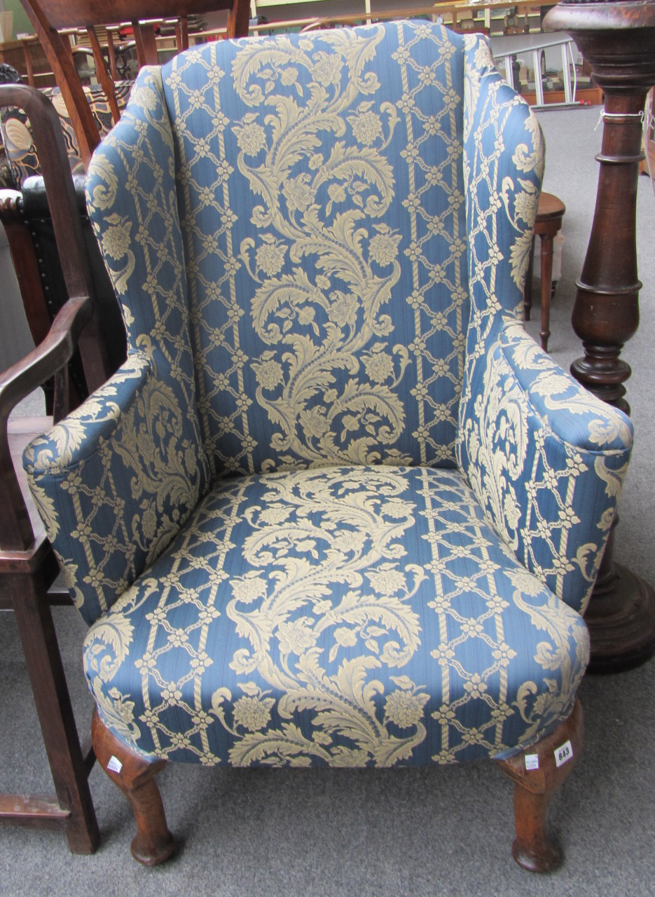 Appraisal: A George III style wingback armchair on cabriole supports