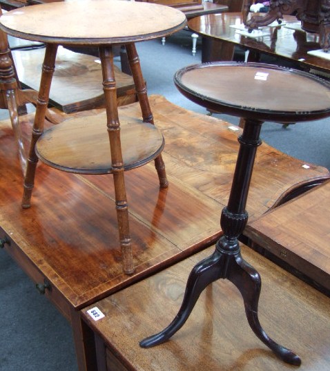 Appraisal: A mahogany two tier occasional table raised on three faux