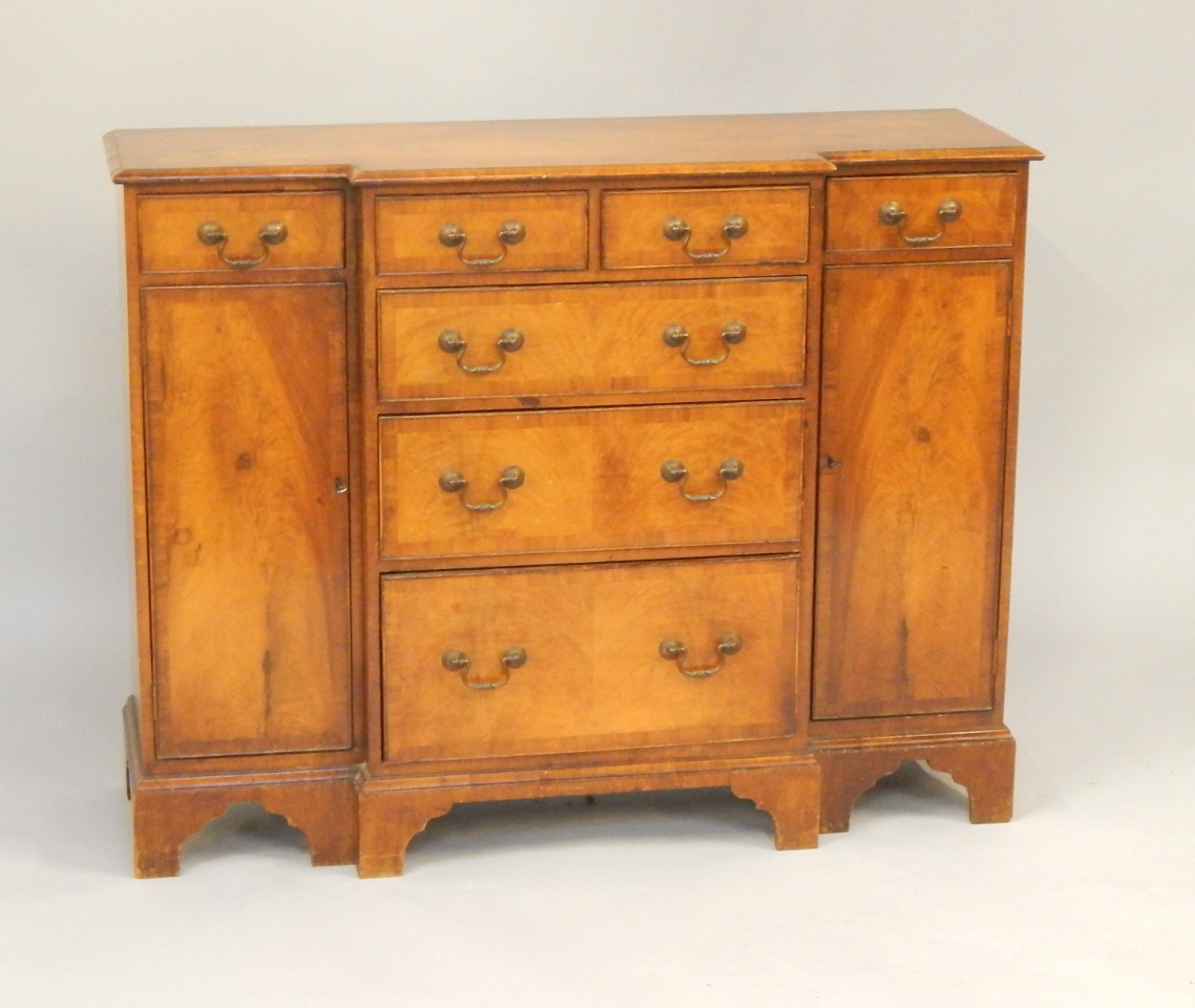 Appraisal: A mahogany break front chest with two short and three