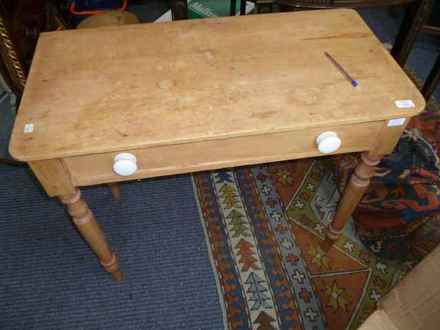 Appraisal: A PINE SIDE TABLE with single drawer and turned tapering