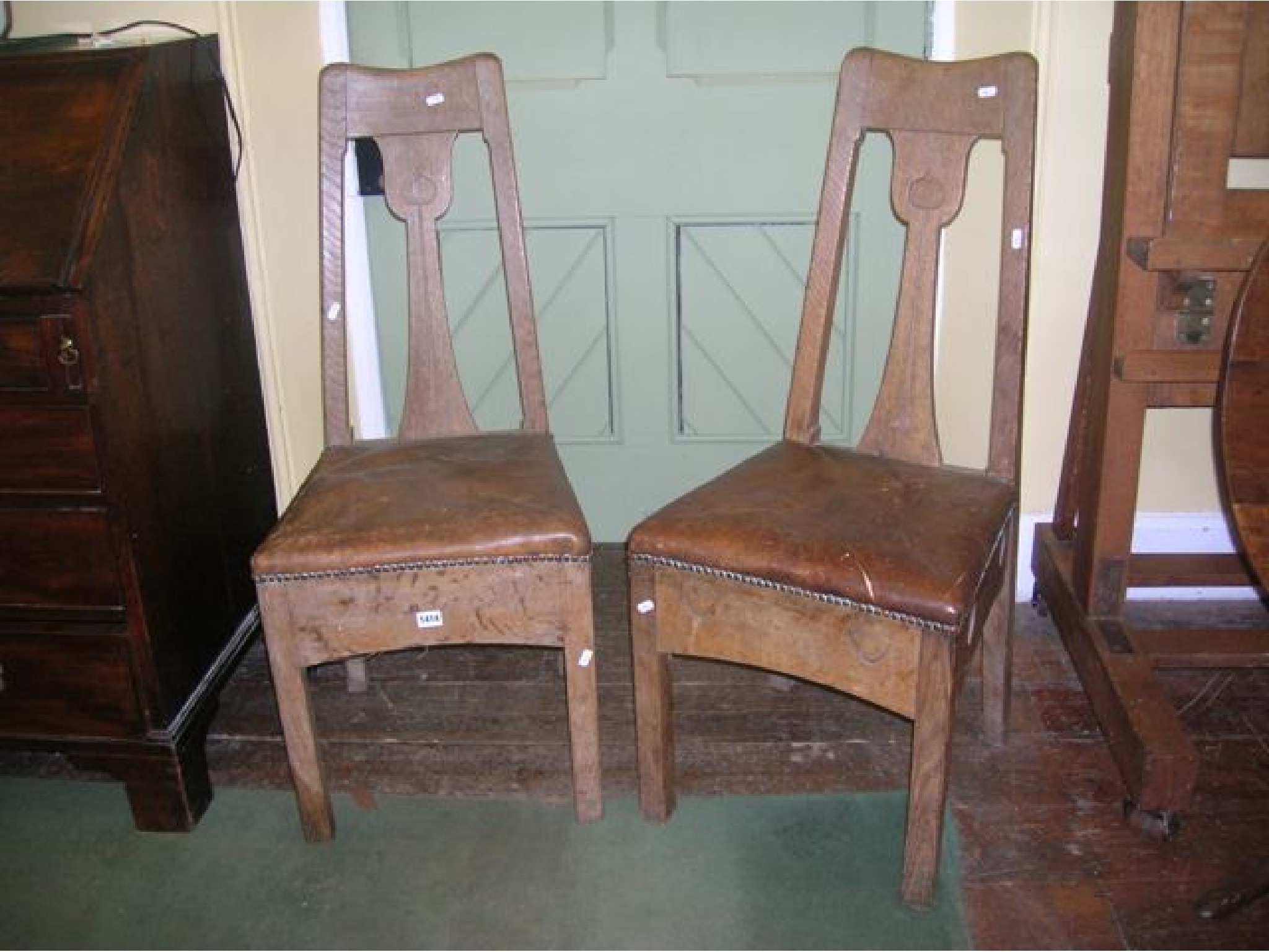 Appraisal: A pair of pure Arts Crafts oak side chairs inset