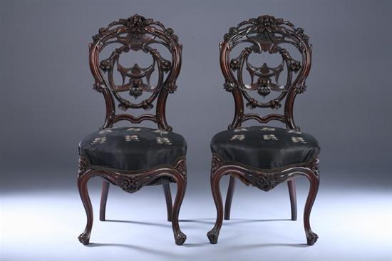 Appraisal: PAIR VICTORIAN CARVED ROSEWOOD PARLOR SIDECHAIRS th century Balloon-shaped backs