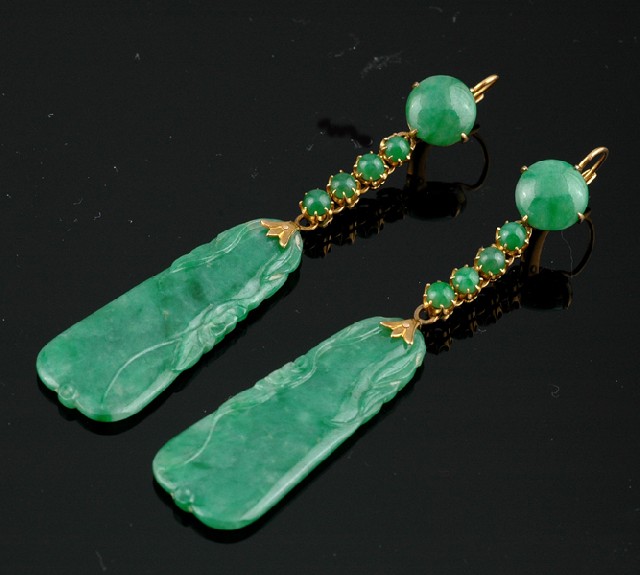 Appraisal: A PAIR OF JADEITE EARRINGS Each having a polished jadeite