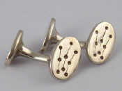 Appraisal: A boxed pair of white metal tests silver cufflinks by