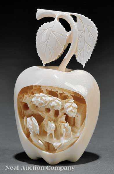 Appraisal: A Chinese Ivory Apple realistic form deeply carved to one