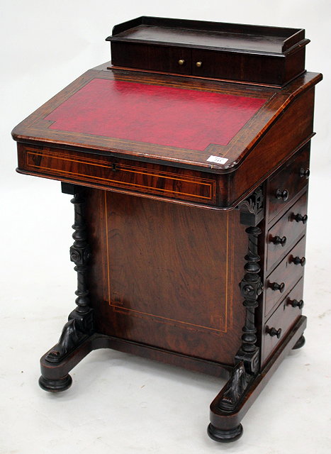 Appraisal: A VICTORIAN WALNUT DAVENPORT with hinged rising lid and drawers