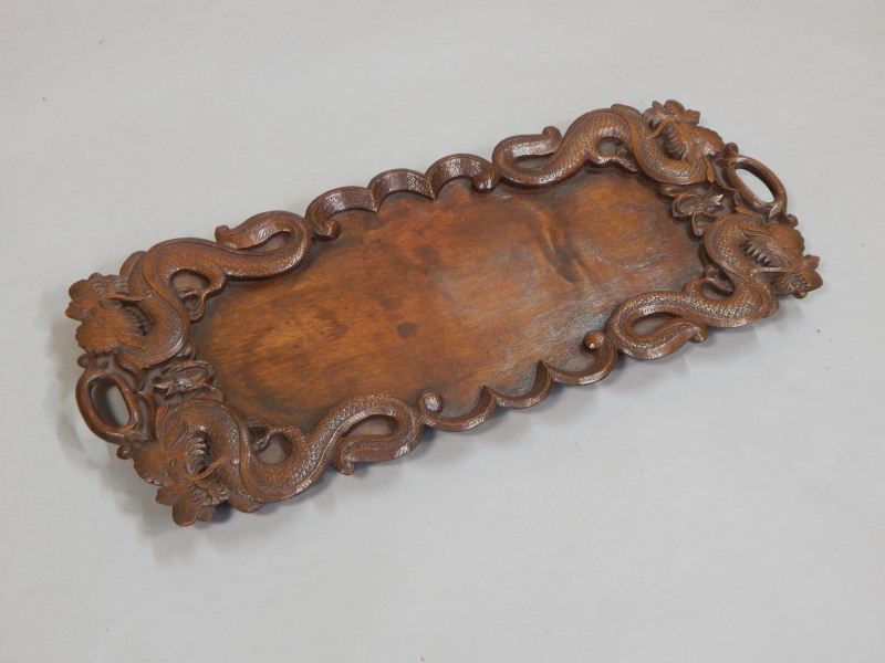 Appraisal: A thC oriental hardwood two handled tray carved with dragons