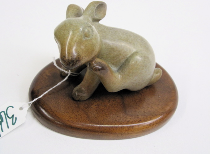 Appraisal: WAH MING CHANG HARDSTONE RABBIT SCULPTURE mounted on wooden plinth