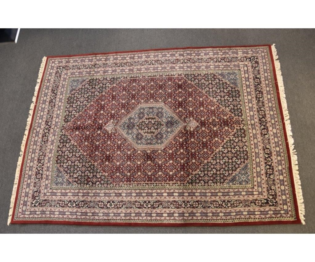 Appraisal: Persian roomsize carpet with blue diamond center medallion red field