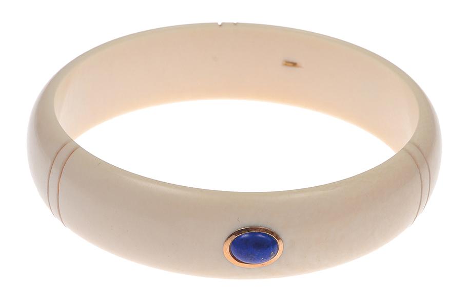 Appraisal: AN IVORY AND LAPIS LAZULI BANGLE The polished ivory bangle