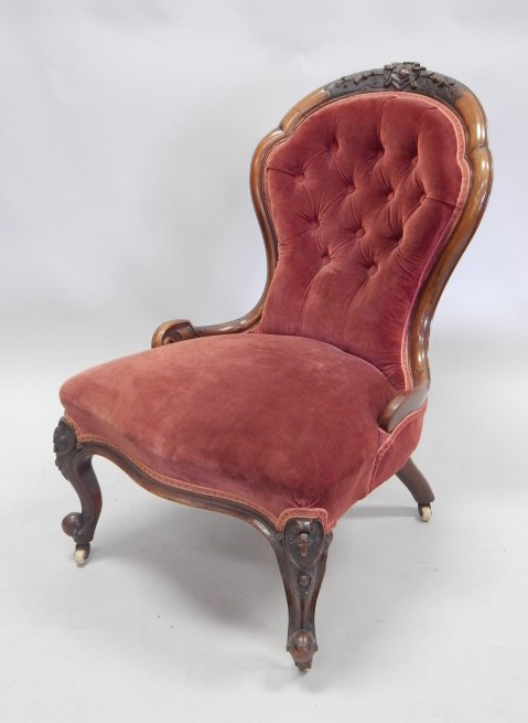 Appraisal: A Victorian walnut nursing chair with a carved show frame