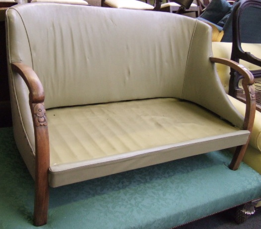 Appraisal: An Art Deco design carved beech frame open arm sofa