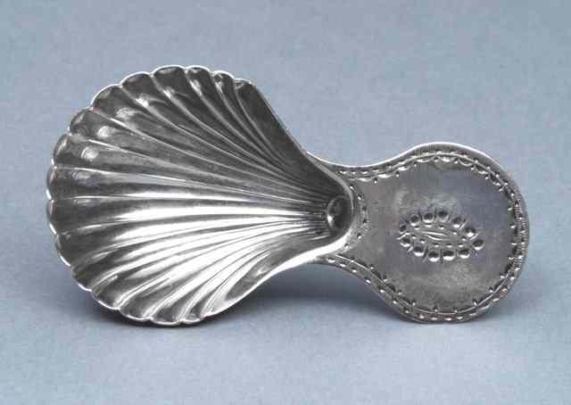 Appraisal: A GEORGE III SILVER CADDY SPOON with scallop shell bowl