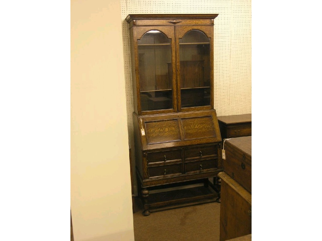 Appraisal: An early th century solid dark oak bureau bookcase bookcase