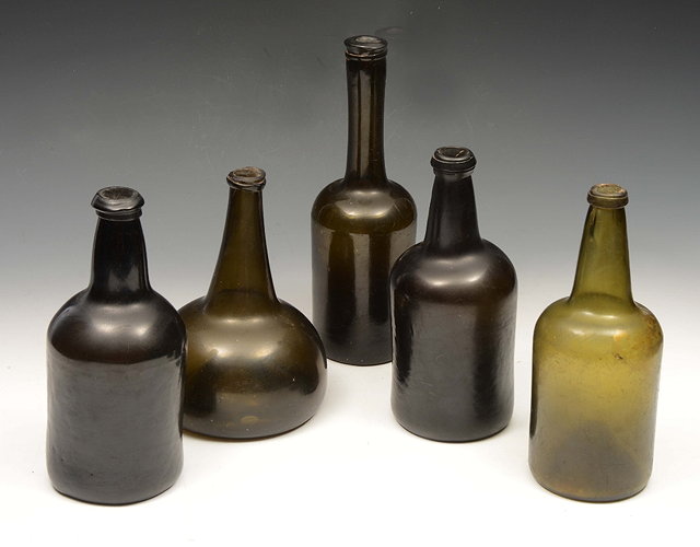 Appraisal: A GROUP OF FIVE ANTIQUE GREEN GLASS BOTTLES of varying