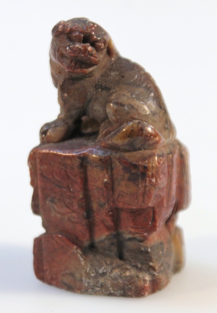 Appraisal: A Chinese soapstone seal in red and grey carved as