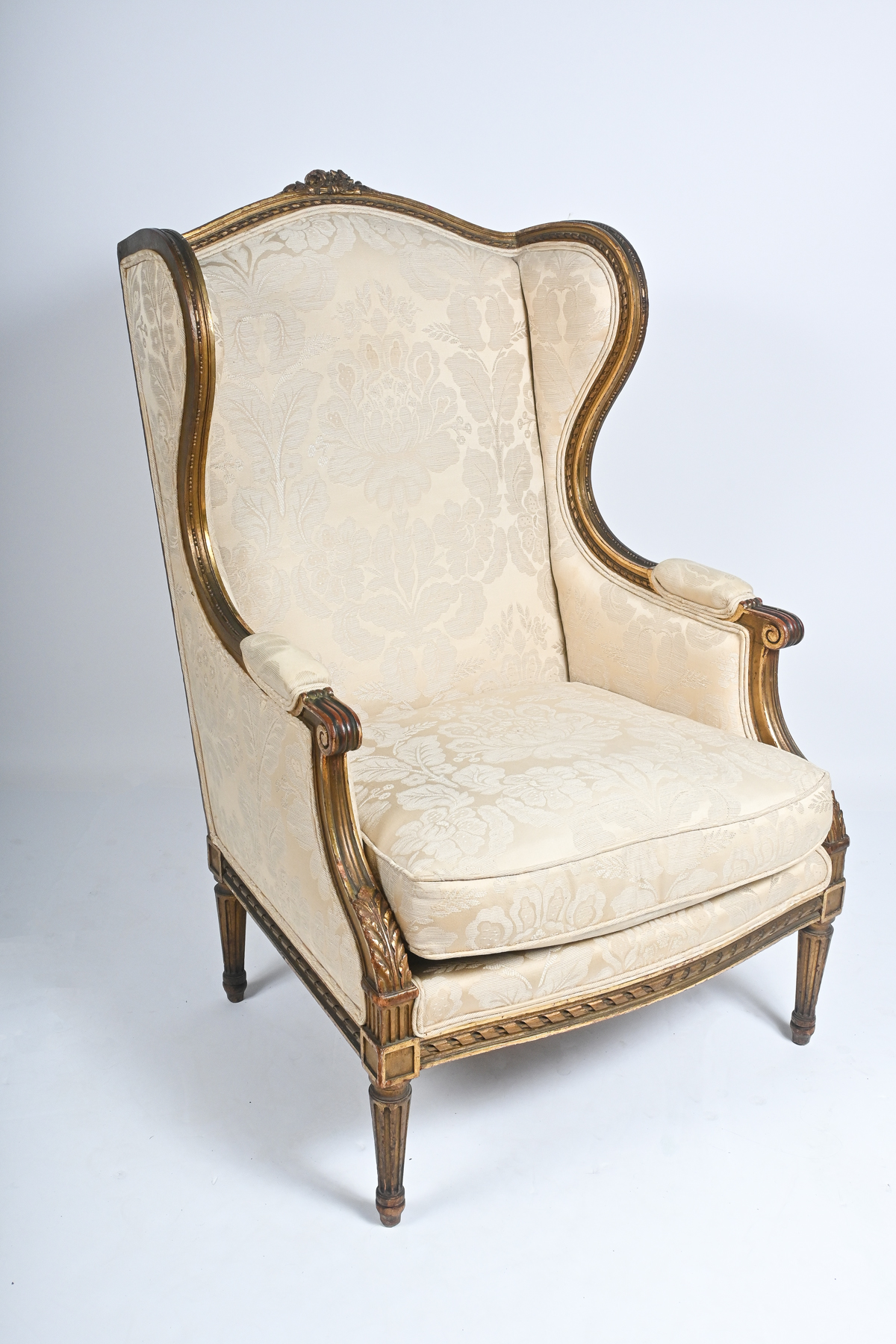 Appraisal: CARVED TH-CENTURY FRENCH WINGBACK ARMCHAIR Carved Gilt Wingback Armchair having