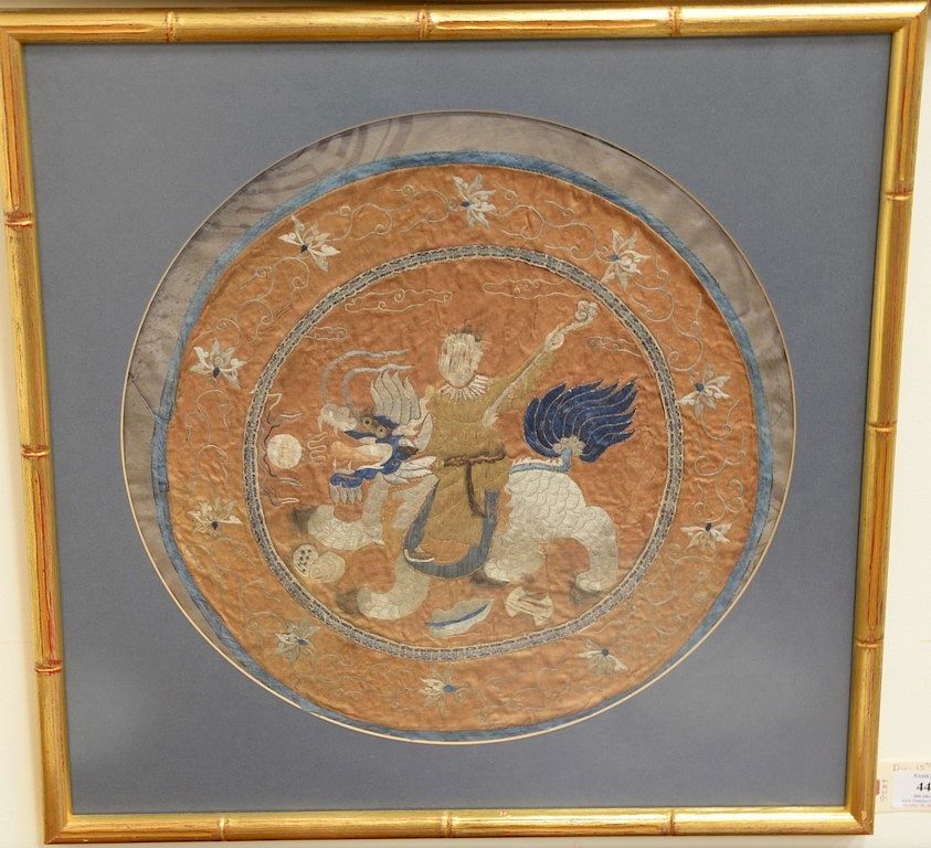 Appraisal: Round silk embroidered panel figure riding foo dog along with