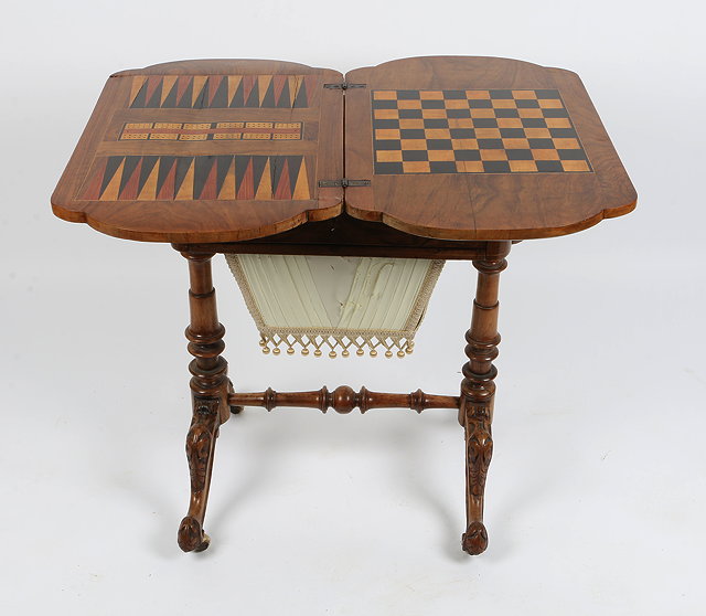 Appraisal: A VICTORIAN WALNUT FOLD OVER GAMES AND WORK TABLE with