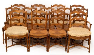 Appraisal: A set of thirteen French walnut rush seated dining chairs