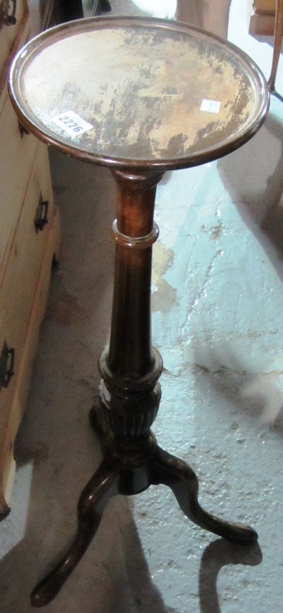 Appraisal: A spiral turned mahogany torchere lacking top another similar and