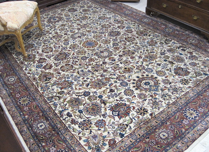 Appraisal: HAND KNOTTED ORIENTAL CARPET Indo-Persian overall floral decorated ivory ground