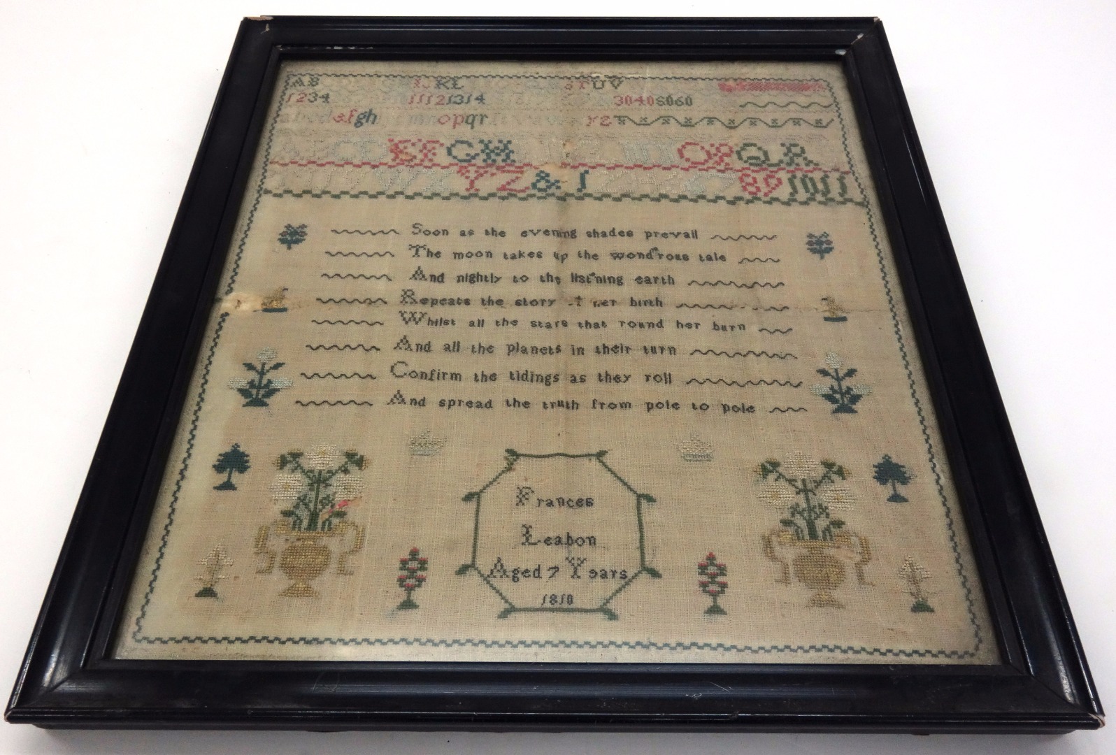 Appraisal: A needlework sampler worked with alphabet and numerals trees flowers