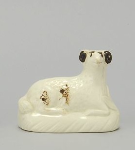 Appraisal: CREAMWARE FIGURE OF A RECUMBENT RAM Circa With dark brown