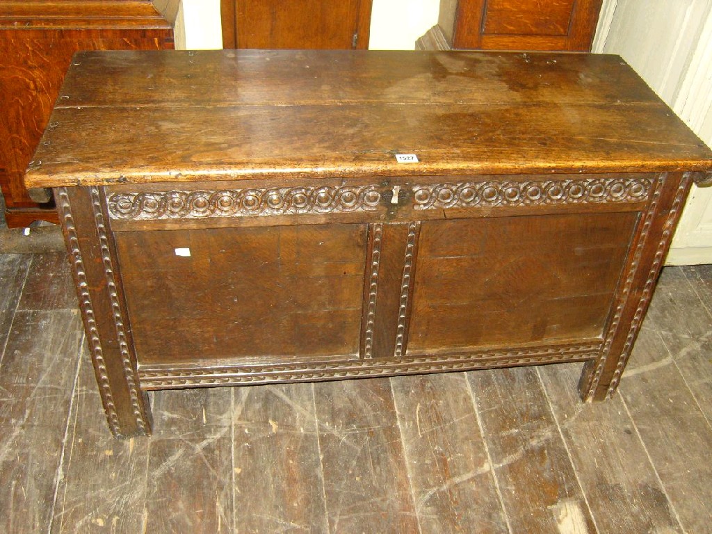 Appraisal: An th century oak coffer with panelled frame and carved