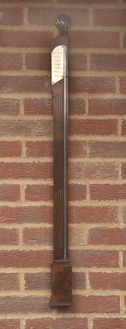 Appraisal: A MAHOGANY STICK BAROMETER with carved flame finial and steel