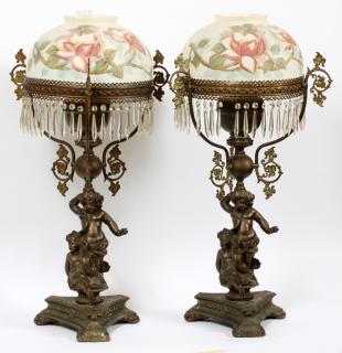 Appraisal: ANTIQUE VICTORIAN METAL CHERUB OIL LAMPS PAIR ANTIQUE VICTORIAN METAL