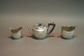 Appraisal: A three piece tea service in sterling silver including creamer