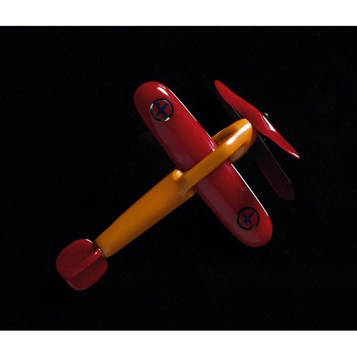 Appraisal: Bakelite pin butterscotch airplane with red tail and moveable propeller