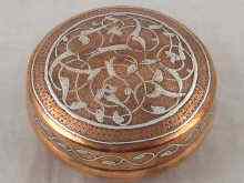 Appraisal: A circular copper box inlaid with white metal in the