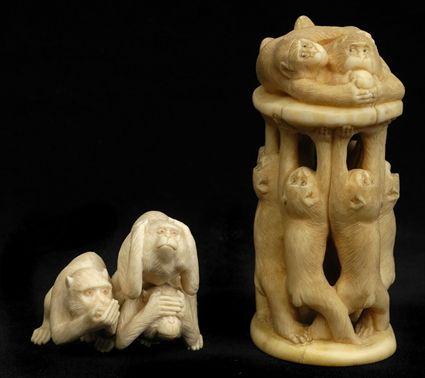 Appraisal: TWO JAPANESE CARVED IVORY MONKEY GROUPS The larger with monkeys