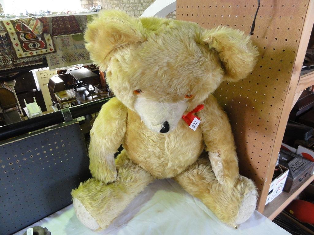 Appraisal: A large teddy bear in gold plush finish with a