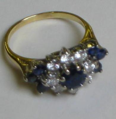 Appraisal: A SAPPHIRE AND DIAMOND CLUSTER RING the central round cut