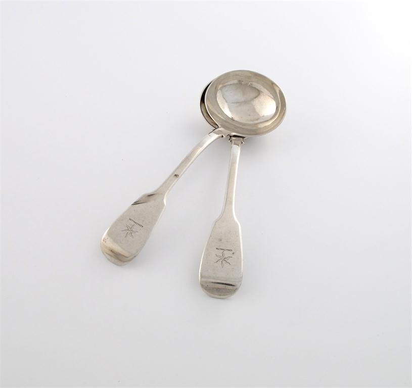 Appraisal: A pair of Victorian silver Fiddle pattern sauce ladles