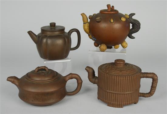 Appraisal: FOUR CHINESE YIXING TEAPOTS one with applied nut decoration one