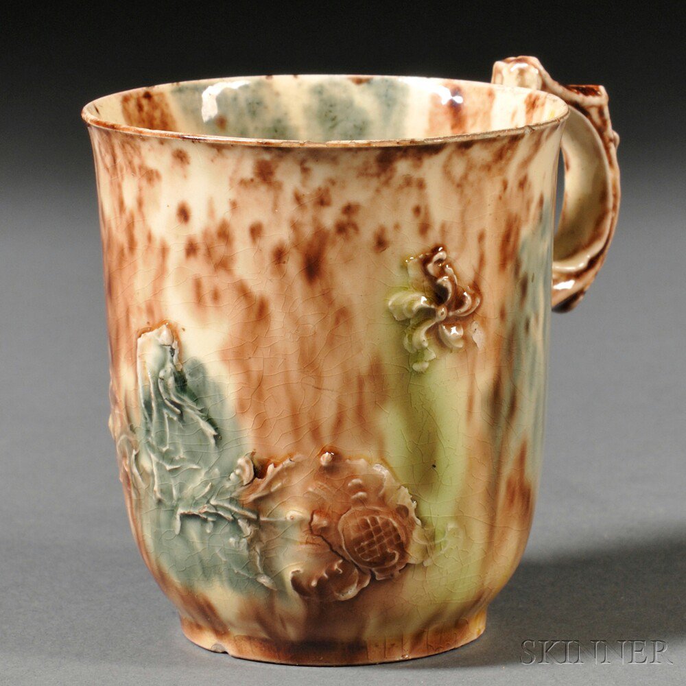 Appraisal: Staffordshire Cream-colored Earthenware Coffee Cup England c with molded S-scroll