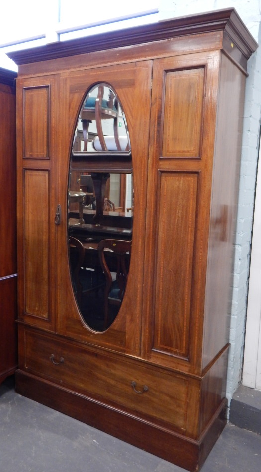 Appraisal: An Edwardian mahogany and marquetry single door wardrobe with an