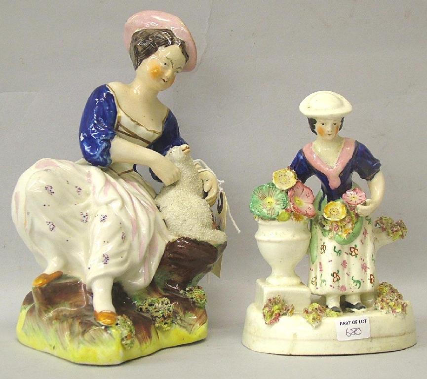 Appraisal: Staffordshire group modelled as a lady seated on a rock