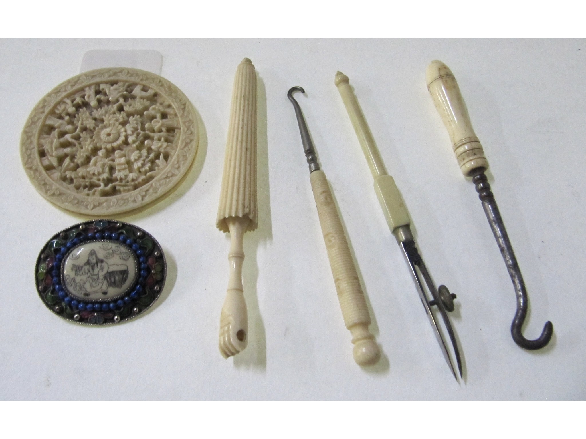 Appraisal: A lot comprising an ivory roundel an ivory gem set