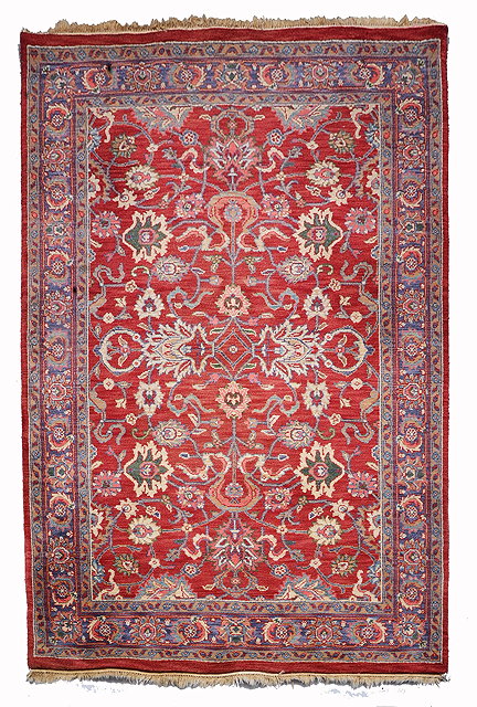 Appraisal: AN INDIAN PERSIAN PATTERN PASTEL RED GROUND RUG with all