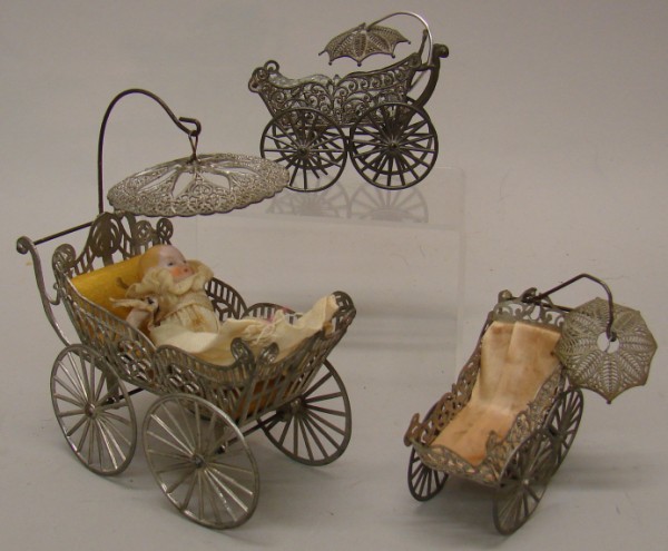 Appraisal: Lot of white metal antique prams with swinging umbrellas Reads