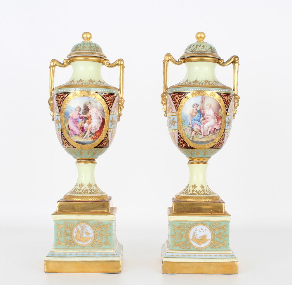 Appraisal: Royal Vienna Style Twin Handled Covered Urns Royal Vienna Style