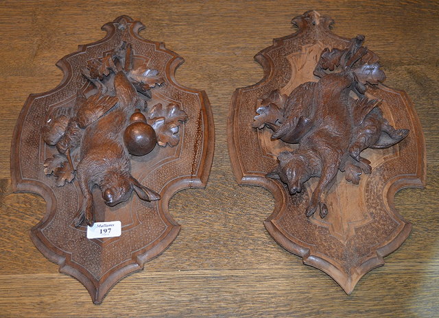 Appraisal: Pair of Black Forest carved wall plaqueseach with a dead